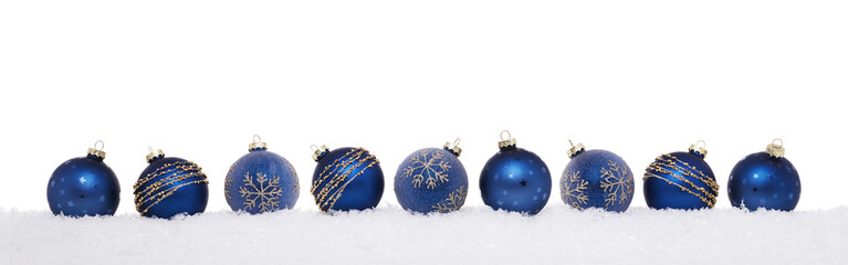 Blue christmas balls in a row isolated on snow, Christmas decoration