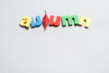 Close-up of word autumn from colorful letters isolated on white background