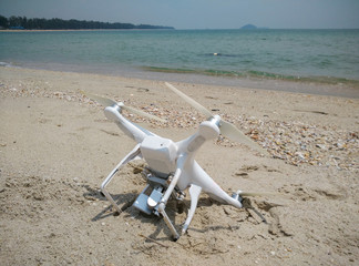 Fototapeta na wymiar Drone fallen from sky to sand beach