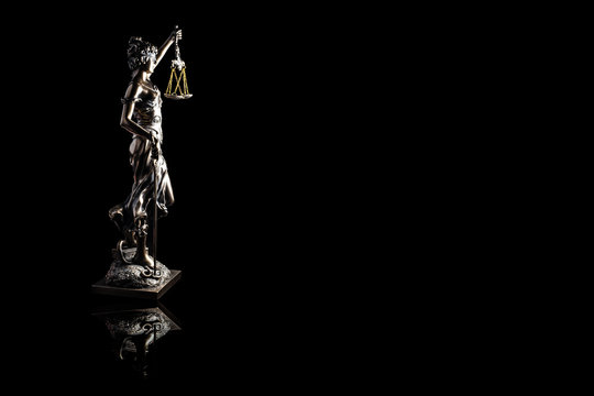 Lady justice or Themis with reflection isolated on black background and space for text