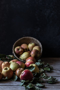Apples and leaves near basket