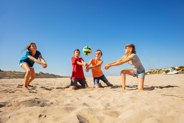 Fototapeta na wymiar Happy beach volleyball players making forearm pass