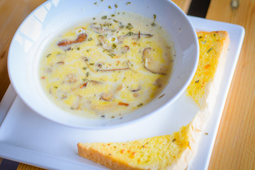 mushroom cream soup with mushrooms, herb and garlic toast on the side