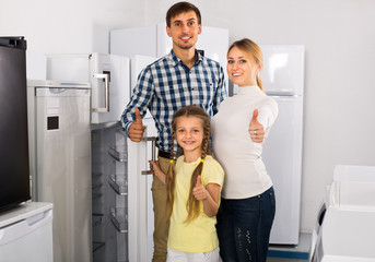 Family with child choosing refrigerator