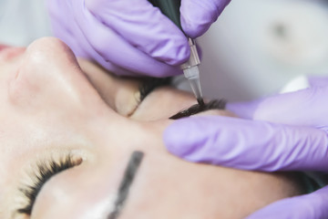 Obraz na płótnie Canvas Female patient on macro eyebrows treatment