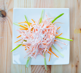 Top view of salad with carrots, garlic and sour cream