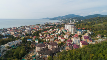 Fototapeta na wymiar aerial view of a coastal town in mountains. Sochi, Russia