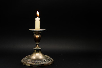 Vintage candle holder isolated in black background