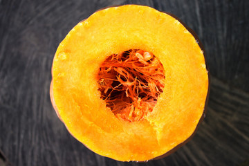 Sliced pumpkin with drops of juice, the core of the pumpkin