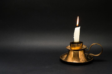 Vintage candle holder isolated in black background