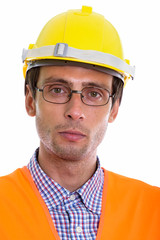 Face of young handsome man construction worker wearing eyeglasse