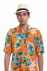 Studio shot of young handsome tourist man ready for vacation