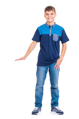 Full length portrait of young caucasian teen boy isolated on white background. Funny teenager showing something by hand. Handsome child looking at camera and smiling.
