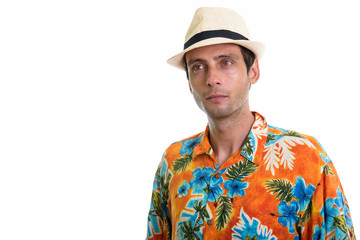 Studio shot of young handsome tourist man thinking ready for vac