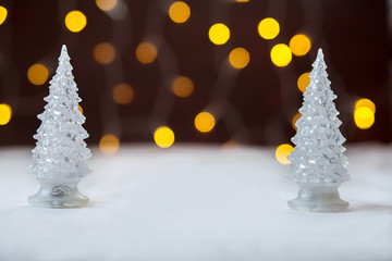 Two toy New Year trees against the background of fires. Bokeh