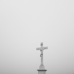 Jesus on a cross lost in the fog