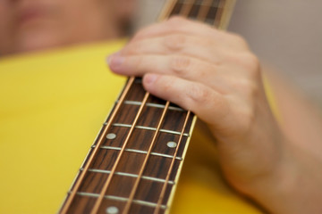Woman holding an acoustic bass guitar