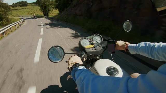 View on motorcycle handlebar with special system or device to hold smartphone. New technology usage, phone attached to steerer with navigation or gps application