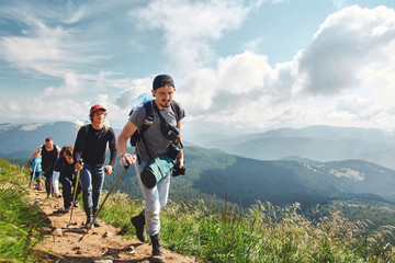 Group of hikers walking by the trail in Carpathians mountains, Ukraine