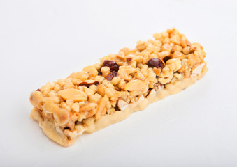 Homemade organic granola cereal bar with nuts and dried fruit on white background