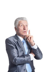 Portrait of senior businessman in formal suit pointing