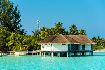 Water villa in a row by the seashore, Maldives. Copy space for text.