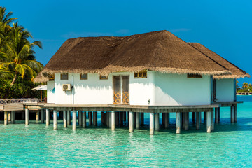 Water villa in a row by the seashore, Maldives. Copy space for text.