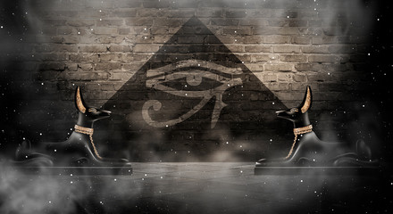 Anubis of Ancient Egypt (God of Death). Dark abstract Egyptian background, dark room with smoke, pyramid, rays of light.