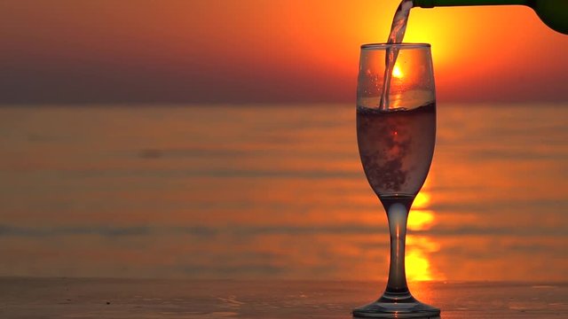 Pouring Champagne In A Glass At Beautiful Sunset In Slow Motion.