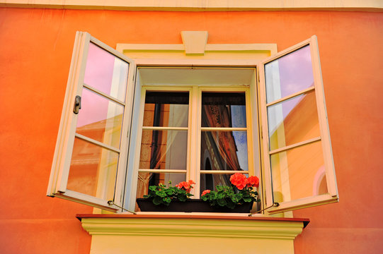 Beautiful open window in orange stone house
