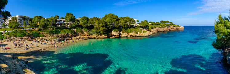 Beautiful wide panorama of Esmeralda beach in Cala d'Or on the coast of Mediterranean sea in...