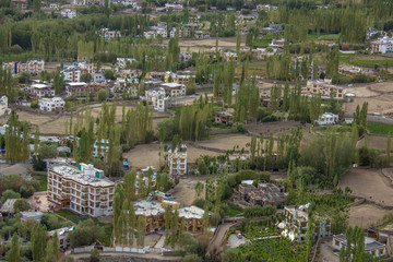 Obraz premium view of a small low-rise town with green trees and fields