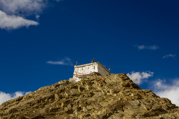 Fototapeta premium Tibetan temple on a rock under a dark blue sky