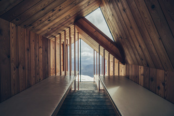 Wooden interior of a free public mountain alpine bivouac shelter. Design architecture interior of a bivi Bivak pod Skuto, Kamnik Savinja Alps, Slovenia.