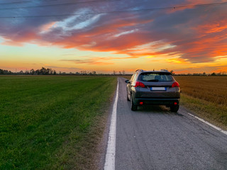 Car on the road at sunset