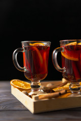 Glasses of mulled wine with cinnamon and orange