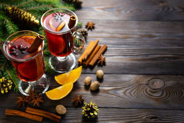 Cups of mulled wine on table with spices