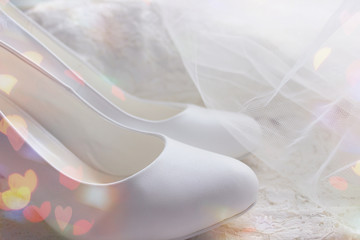 Obraz na płótnie Canvas The background of the wedding day. White on white. White shoes. wedding shoes. Bride`s high heels. The fees of the bride. Wedding jewelry.