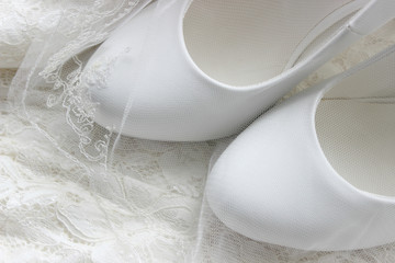 Obraz na płótnie Canvas The background of the wedding day. White on white. White shoes. wedding shoes. Bride`s high heels. The fees of the bride. Wedding jewelry.