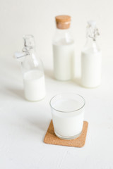 Milk in bottles on white background, kitchen