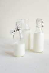 Milk in bottles on white background, kitchen