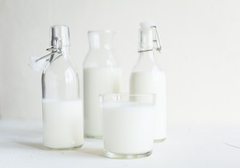 Milk in bottles on white background, kitchen