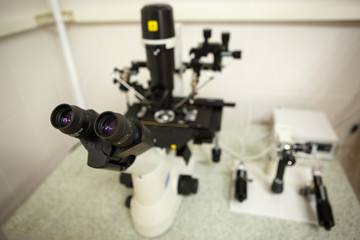 The equipment in the laboratory of the clinic of in vitro fertilization IVF. Microscope, tubes, nitrogen, other devices for chemical manipulations in the laboratory