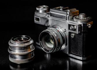 vintage camera and vintage lens on black background
