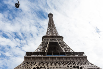 View of the Eiffel Tower in the city of Paris in sunny day with security camera.