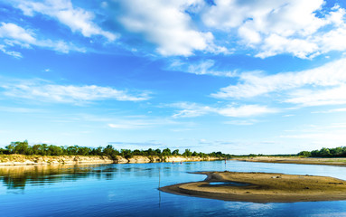 Dried shallow river with small sandy islands due to drought and no rain. A wonderful summer day in the shallow river. Belarusian Polesie. Pripyat National Park