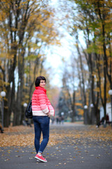 Girl in a yellow autumn park.