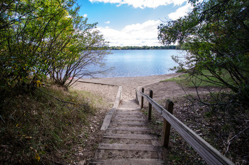 Stairs and steps walkway path down to Lake Ann in Zimmerman, Minnesota on a summer day