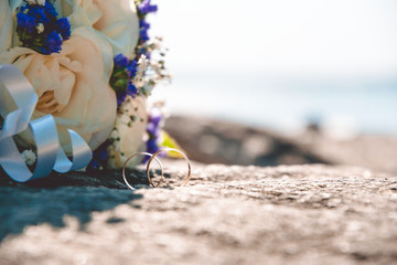 Gold wedding rings on a background of a sea landscape