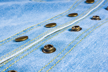 Blue washed faded jeans texture with seams, clasps, buttons and rivets
